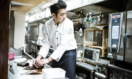 Chef in front of intelligent RATIONAL combi oven - a great support against skill shortage