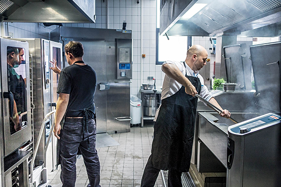 Hard working staff in modern and intelligent commercial kitchen