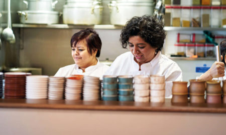 Top chef Asma Khan standing in her kitchen at Darjeeling Express