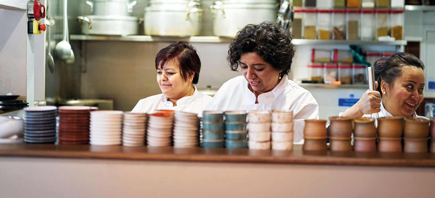 Top chef Asma Khan standing in her kitchen at Darjeeling Express