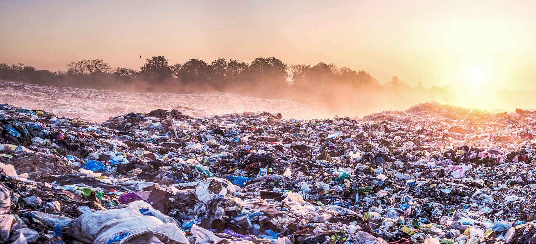Plastic waste dump at sunrise