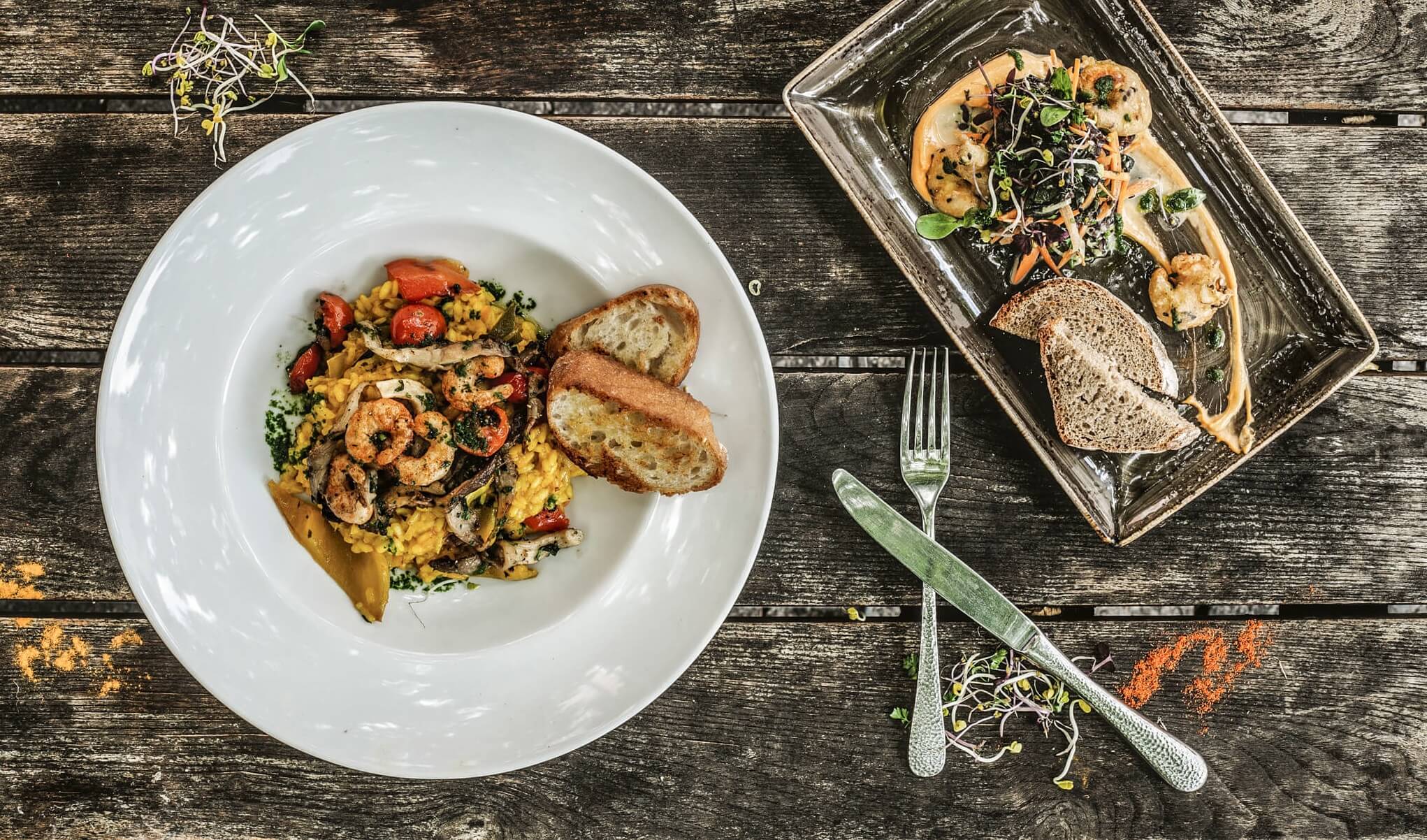 Pasta and salad with vegan alternative for shrimps served on a restaurant plate.