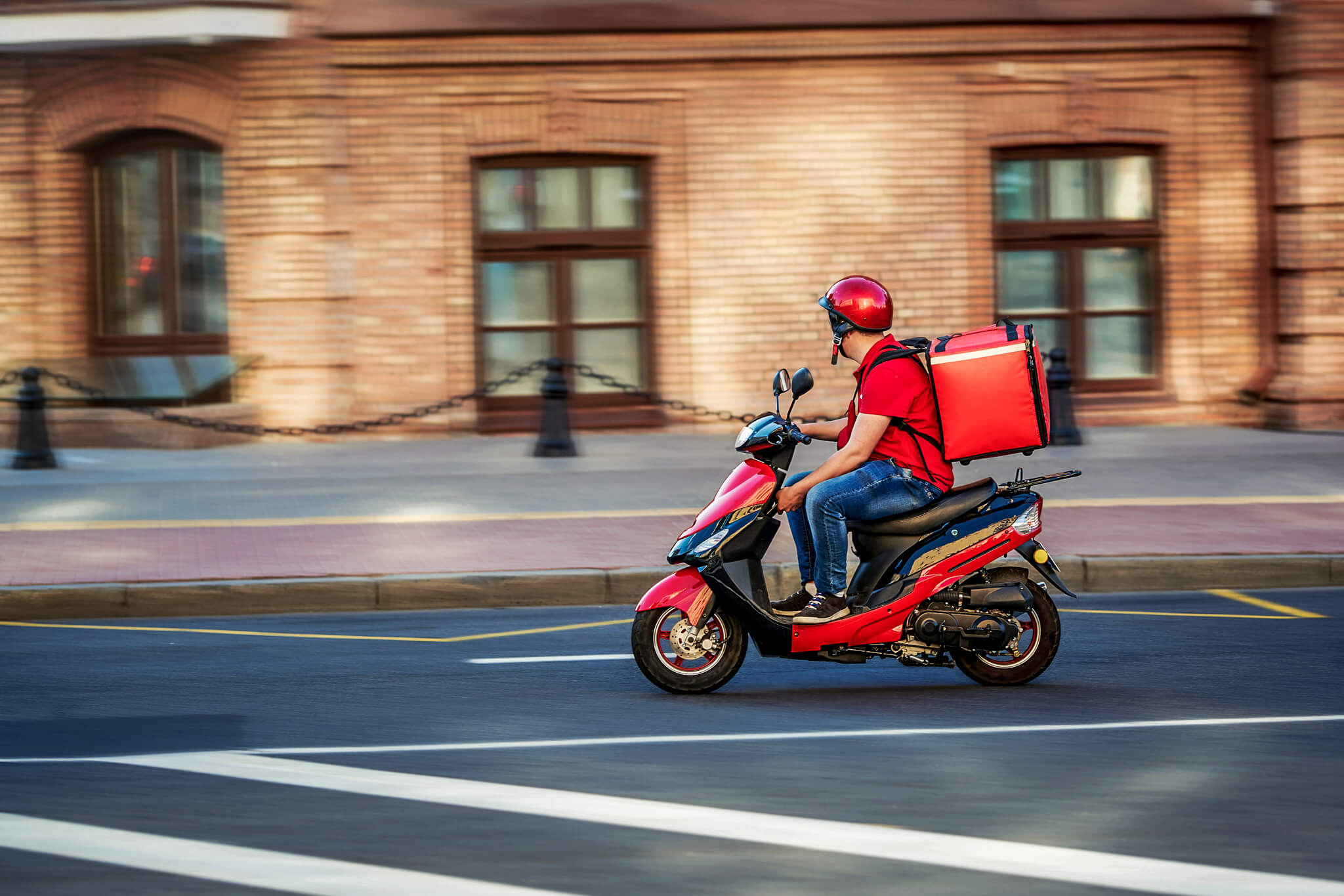 Man on motorcycle delivering food to customers