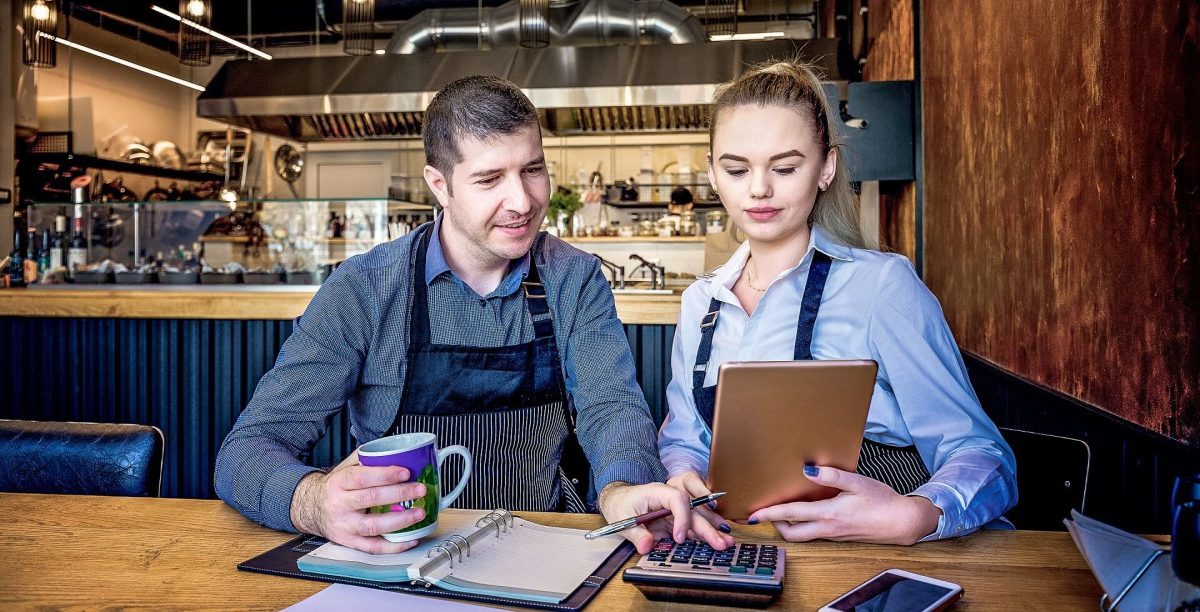 Chef and employee updating allergene list.