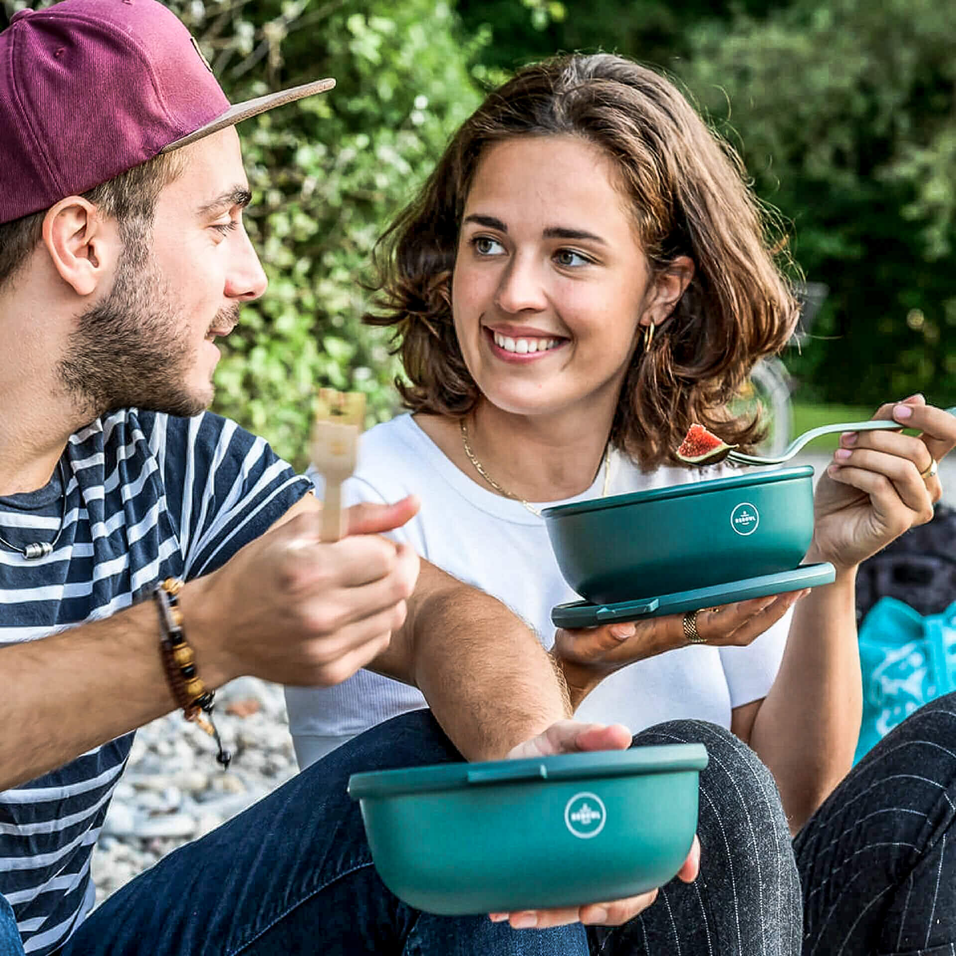young couple eating some food placed in sustainable rebowl containers