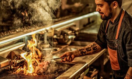 Inspiring chef cooking a steak - a true hero of Hospitality 2021