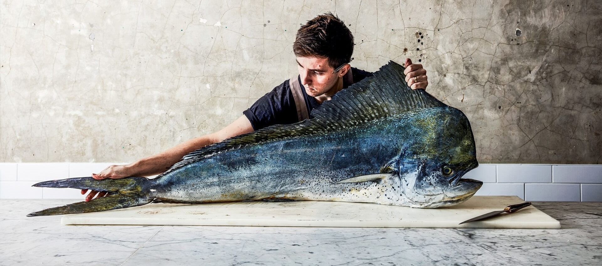 Dry Aging guru Josh Niland preparing a fish for being cut.