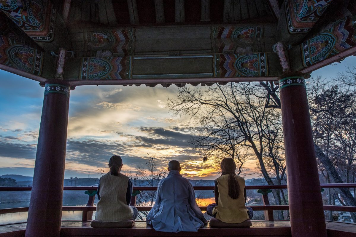 Three people visiting a Korean Temple in which traditional Korean temple cuisine is offered.