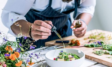 Chef using essential oils to flavour a salad