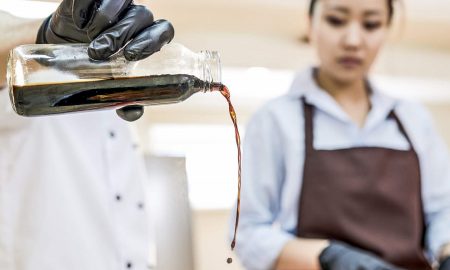 A chef and a cook just using an umami rich soy sauce