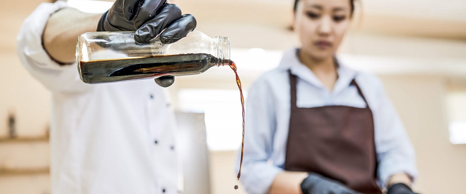 A chef and a cook just using an umami rich soy sauce