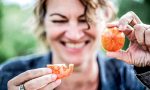 Hanni Ruetzler smiling with tomatoes in hand