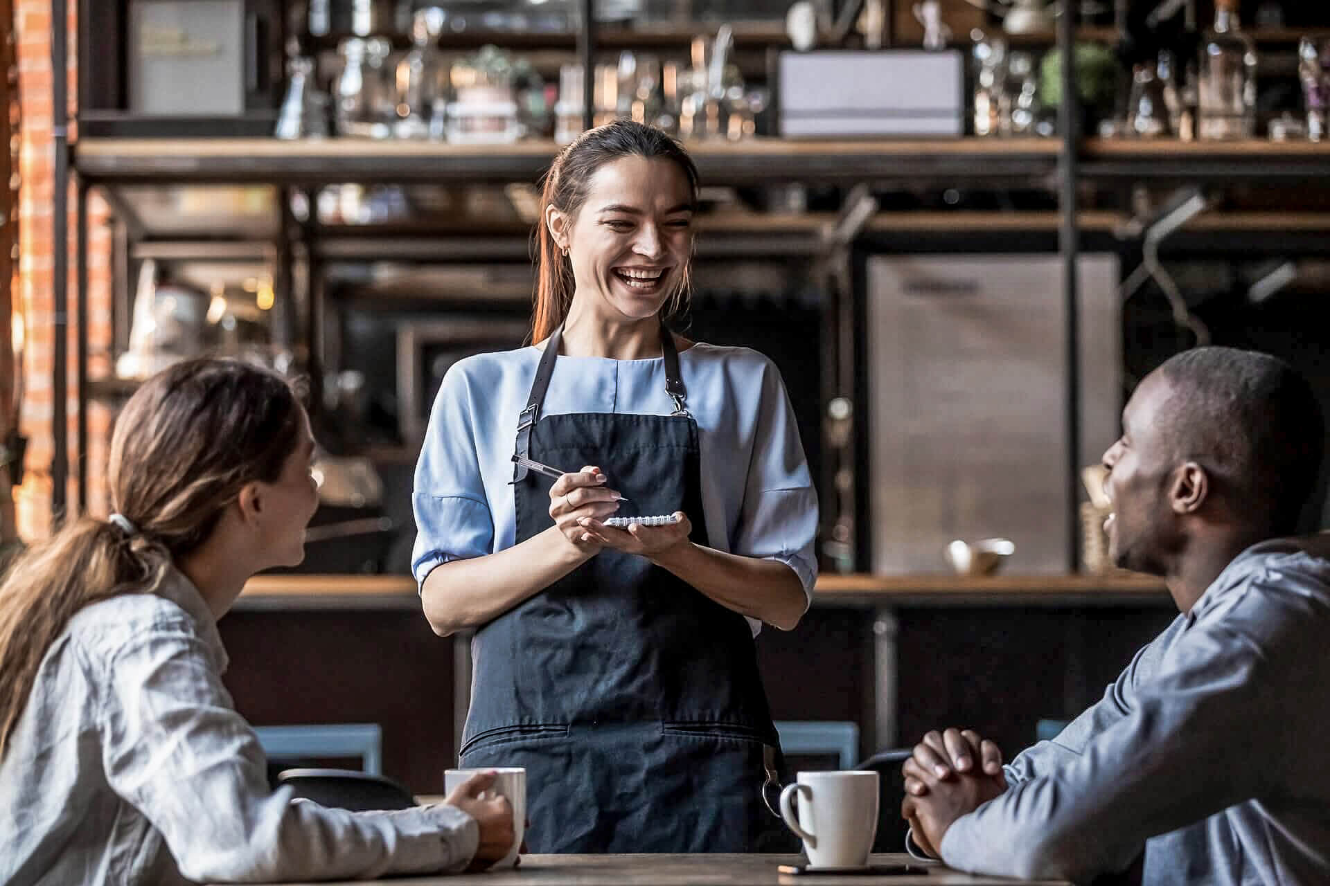 Waitress takes order from two guests