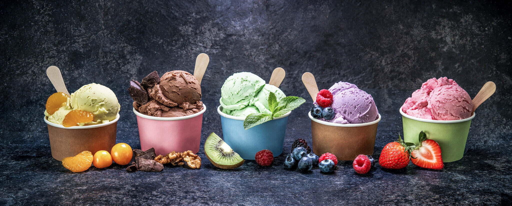 Ice cream scoops in cup with different flavors