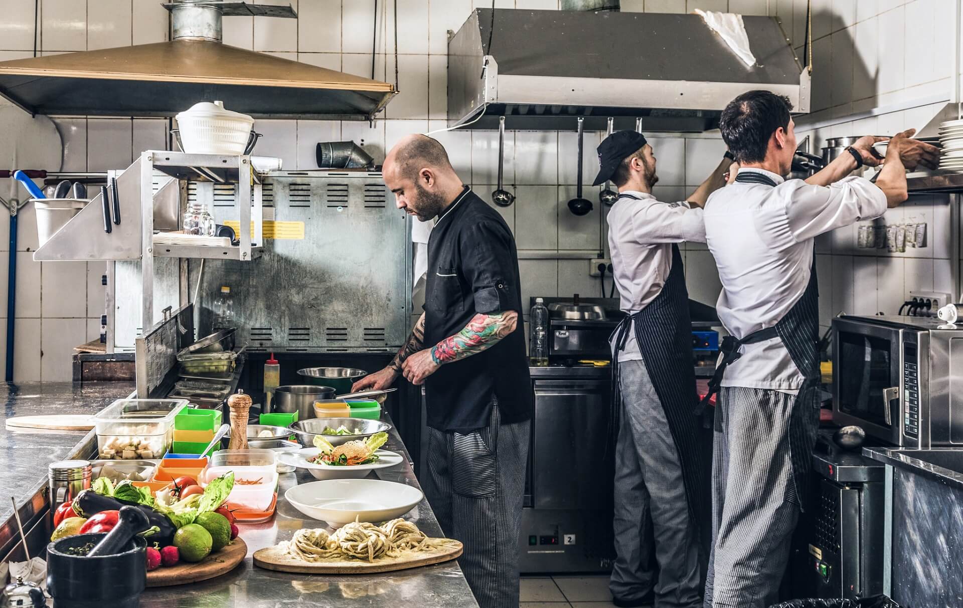 Adequately trained staff preparing dishes for indoor and outdoor dining.