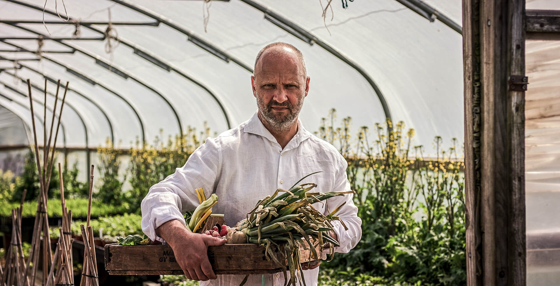 Simon Rogan at Cartmel Farm in a greenhouse