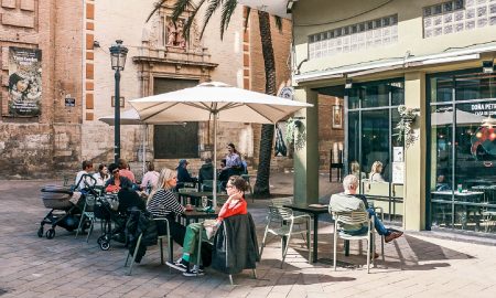 Customers sitting in the outdoor dining area of the restaurant Doña Petrona in Valencia.