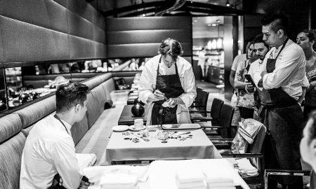 Grant Achactz cooking in the guest room. To prevent no-shows he sells tickets instead of reserving tables