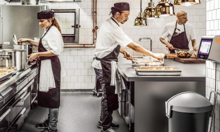 A group of chefs work in a kitchen that uses AI to reduce food waste in the gastronomy industry