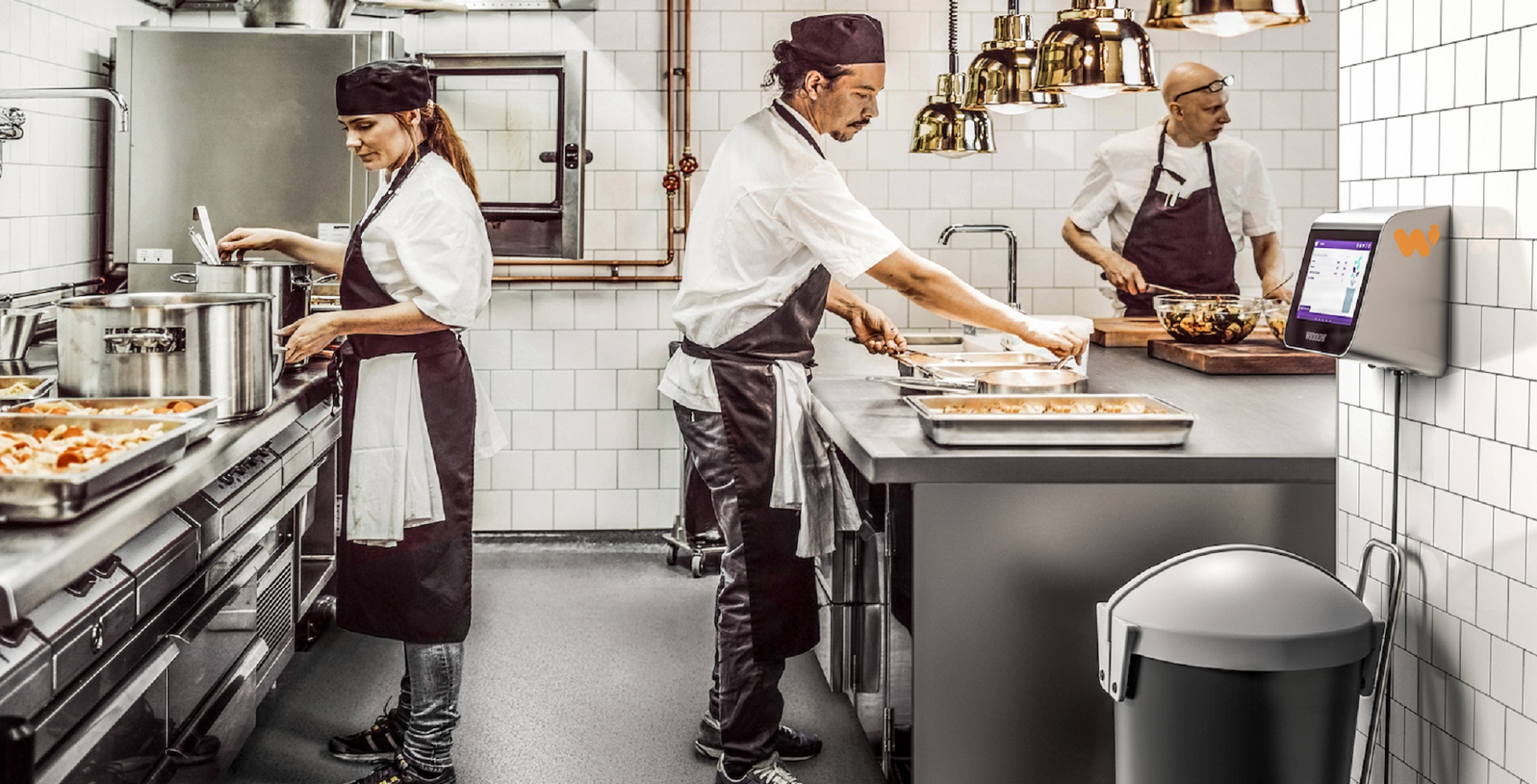 A group of chefs work in a kitchen that uses AI to reduce food waste in the gastronomy industry