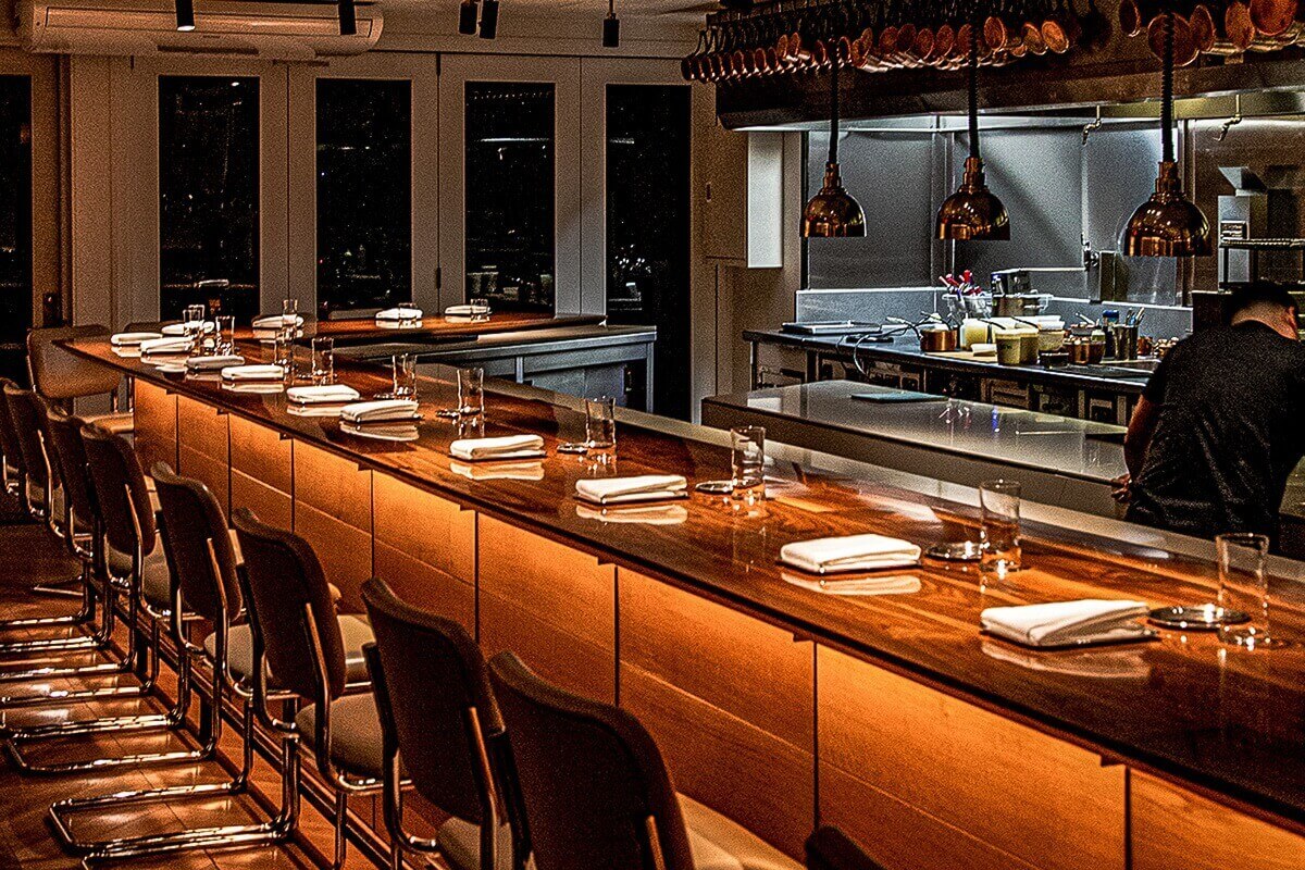 The Chef's Table At Brooklyn Fare has a shared table in the form of a bar.