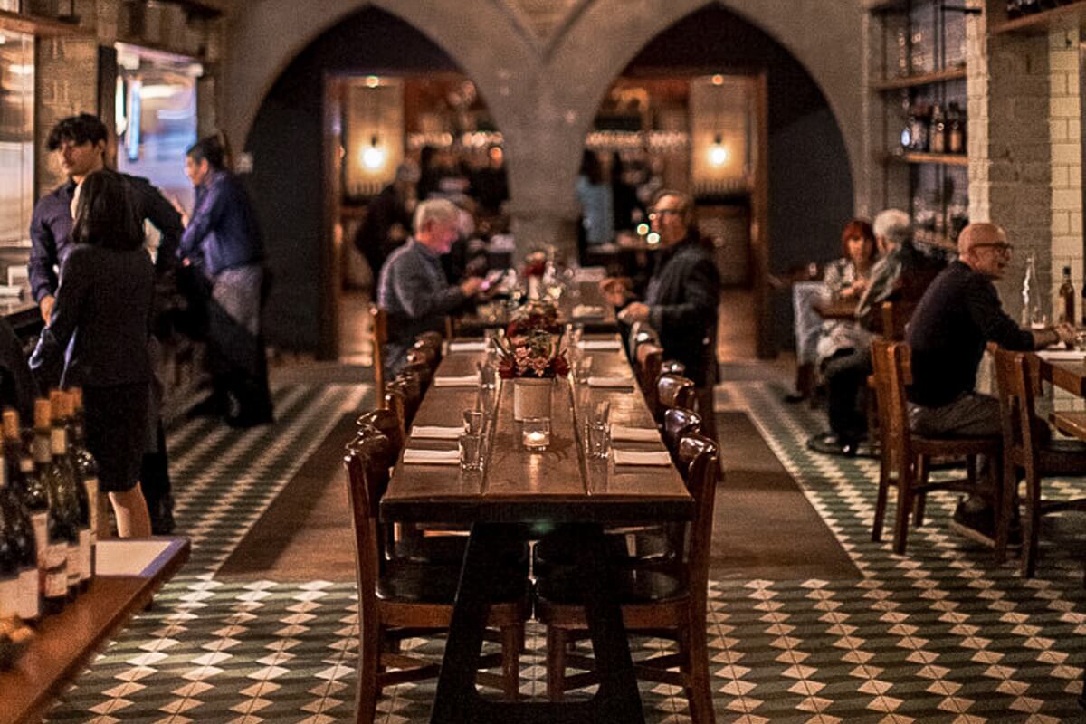 Long, wooden shared tables at the République .