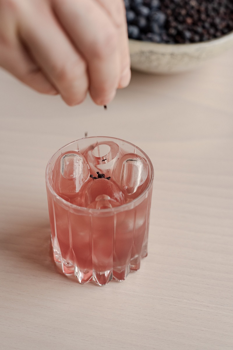 A pink drink is being decorated