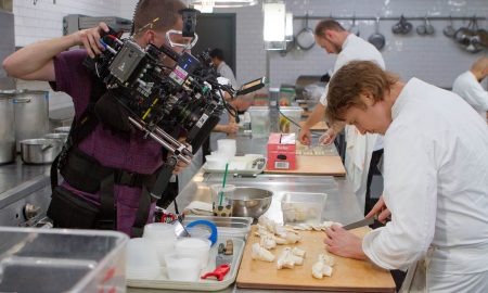 A camera team is filming Grant Achatz in his professional kitchen