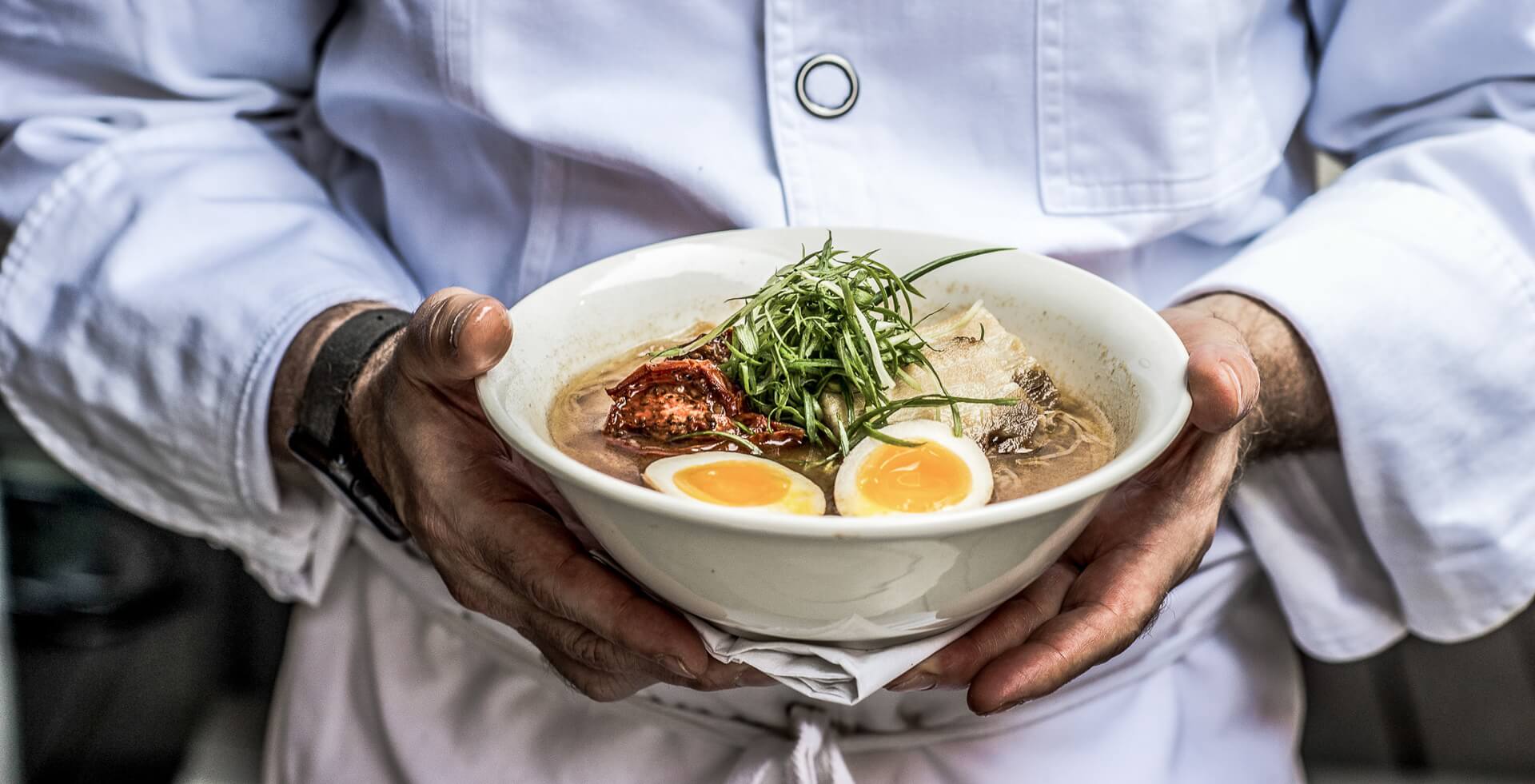 prepared ramen in the hands of the ramen god Ivan
