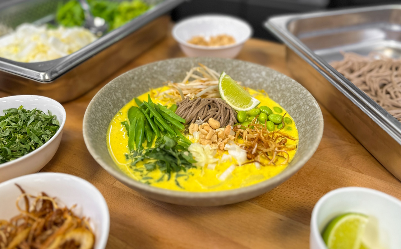 Yellow curry bowl with soba noodles, served with the ingredients.