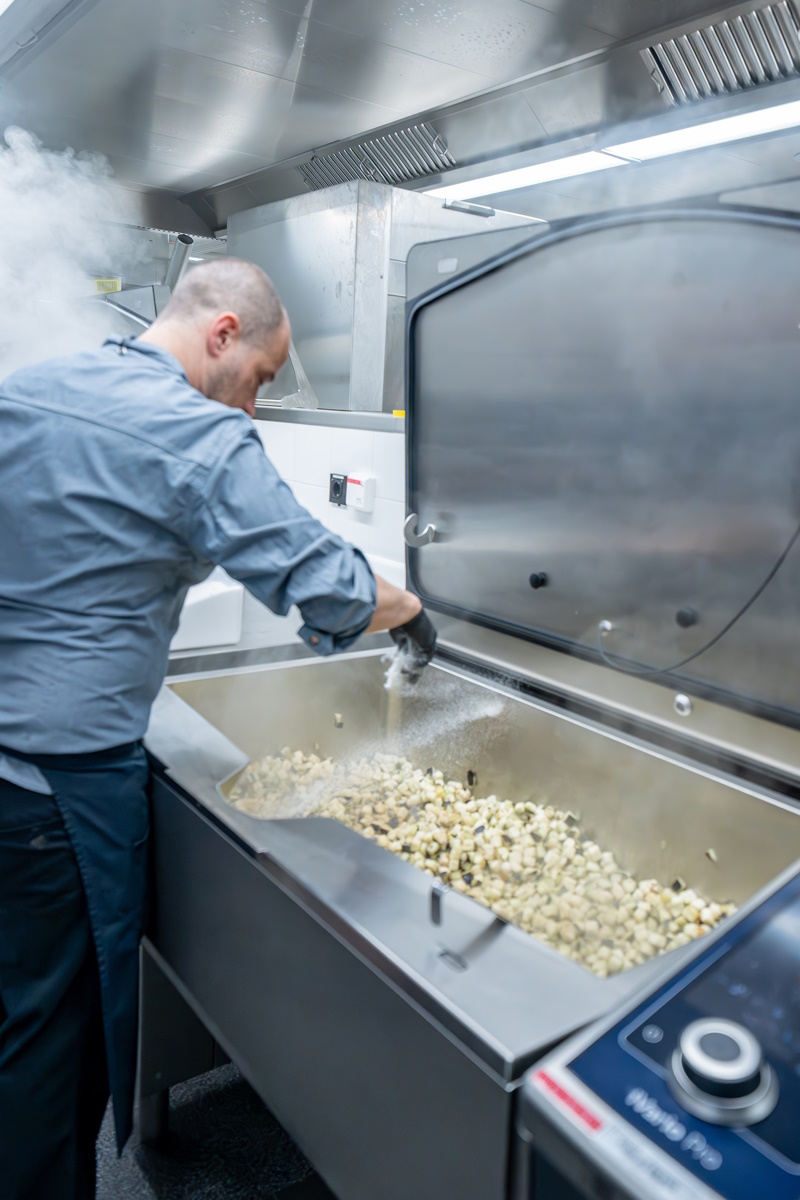 Chef salting the dish in the iVario Pro.